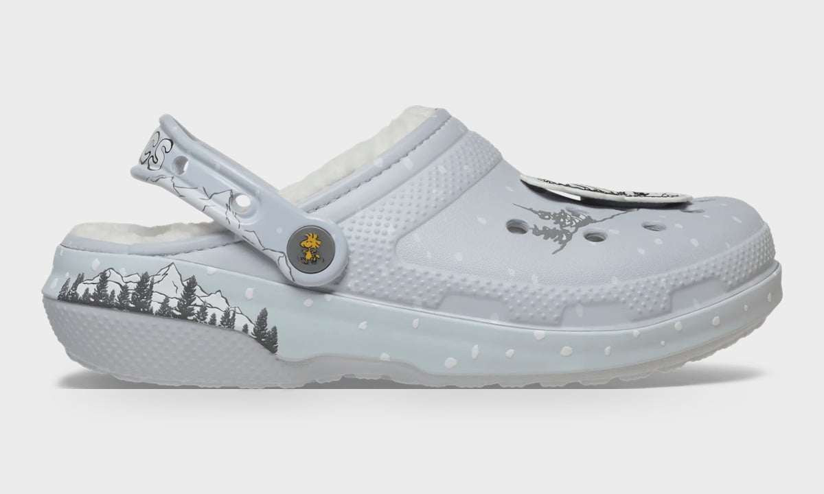 Lateral view of grey clog with white fleece lining, pine and mountain print, snow dots and yellow bird button, Classic Lined