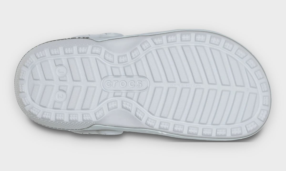 Outsole of grey clog with ridged tread and crocs logo in the centre, Classic Lined Clog