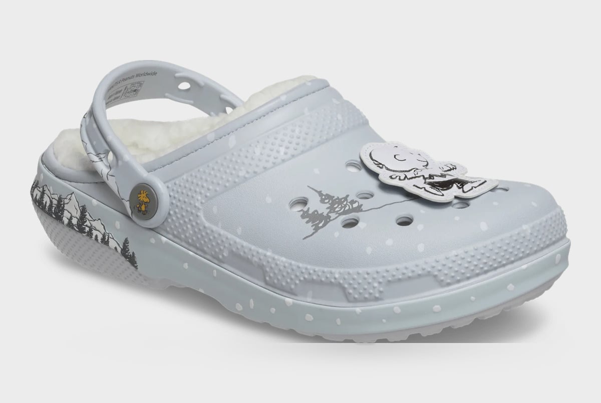 Three-quarter view of grey clog with fleece lining, snow dots and a white cartoon charm on the toe, Classic Lined Clog