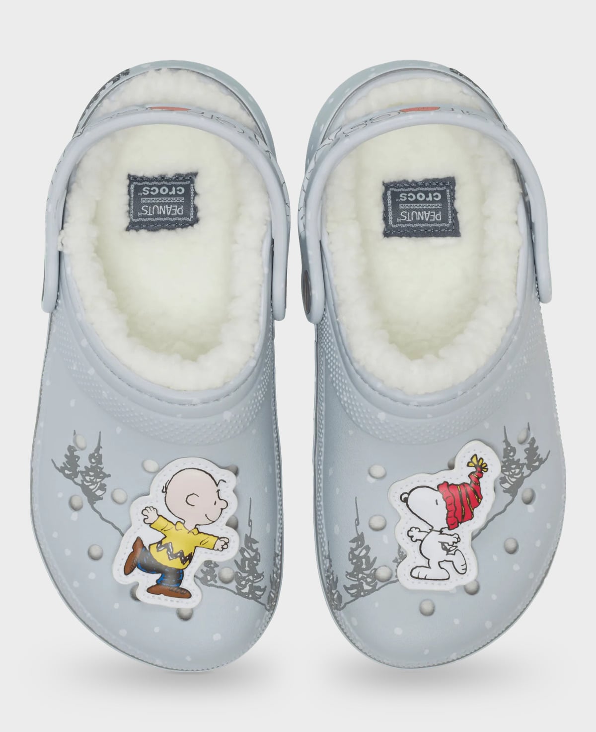 Top-down view of grey clog pair with fleece, Peanuts Crocs insole patches, yellow shirt and red hat charms, Classic Lined