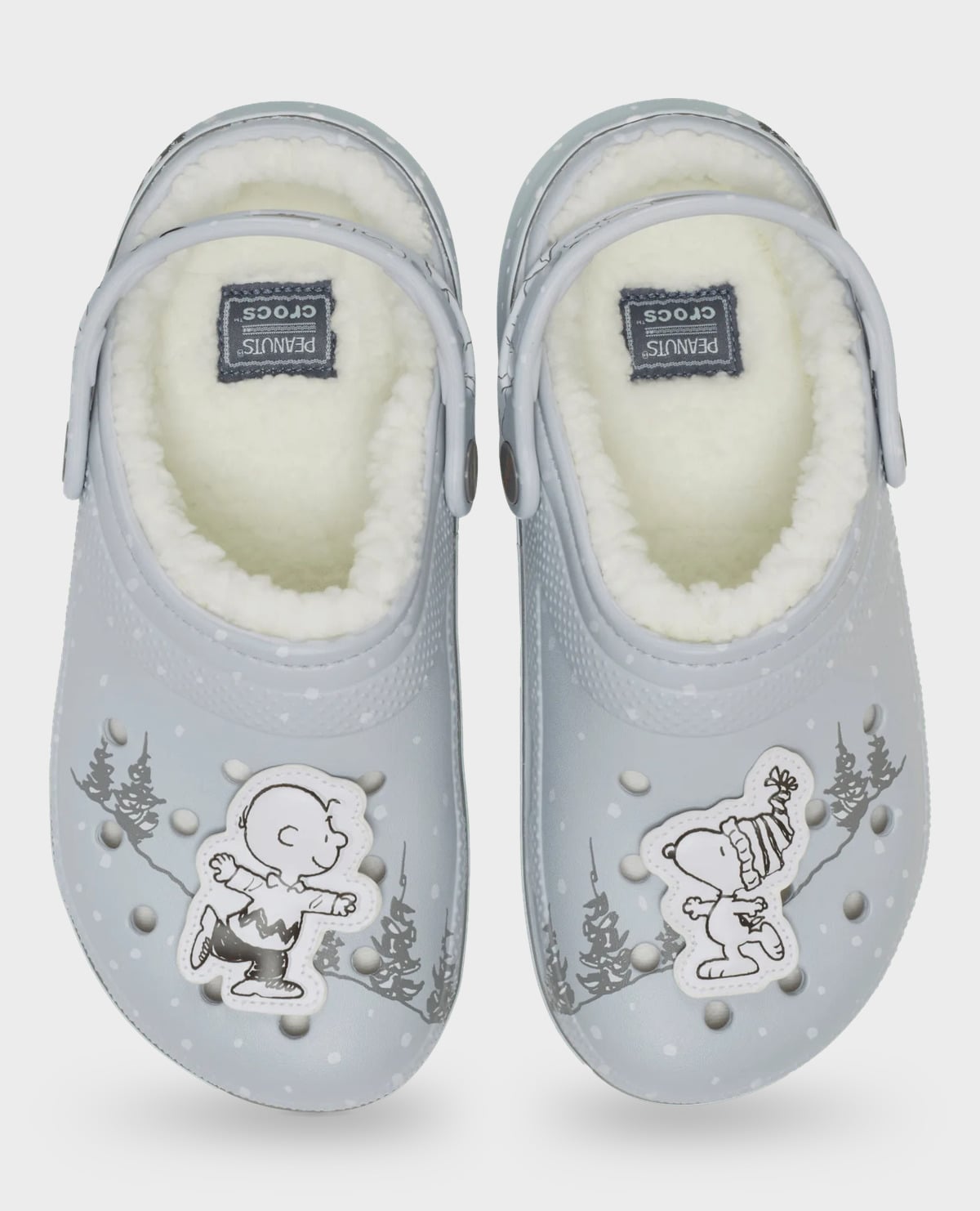 Top-down view of grey clog pair with fleece, Peanuts Crocs insole patches, black-and-white charms, Classic Lined Clog