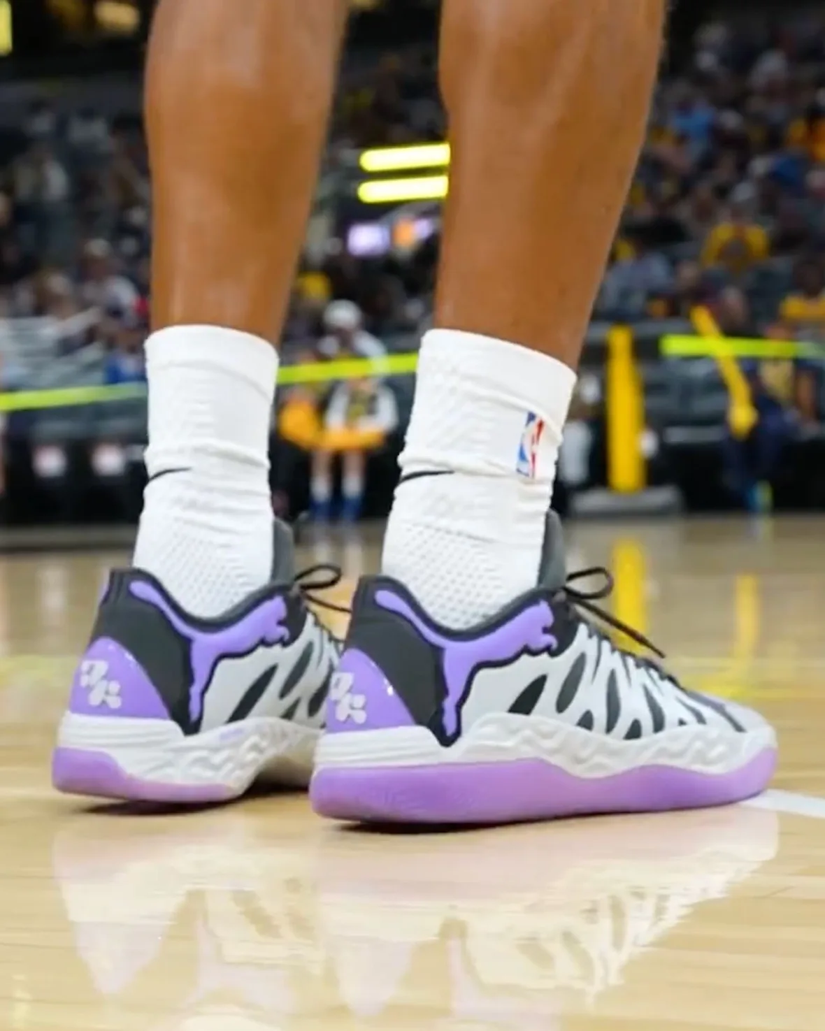 On-foot heel view on court, purple PUMA cat logo and purple heel tab with white logo, Teddy Lockart