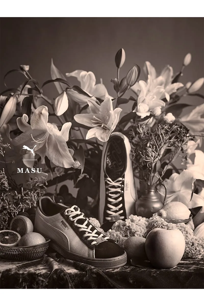 Sepia still life of sneakers among lilies, lemons and an apple, PUMA MASU logo at left, IVORYxBLACK