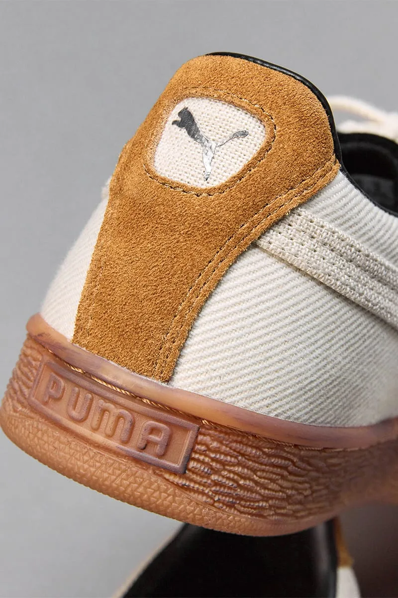 Heel detail, tan suede tab with silver cat logo, raised PUMA lettering on gum sole, IVORYxBLACK