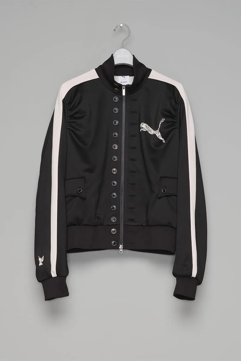 Black zip track jacket on hanger, cream sleeve stripes, row of buttons, distressed cat logo, IVORYxBLACK