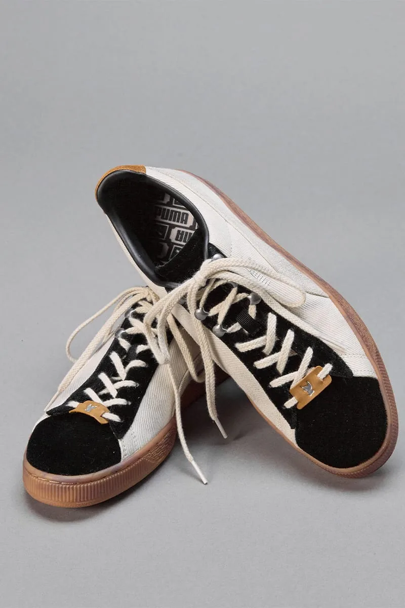 Stacked pair, one tilted to show PUMA-print lining, cream twill, black suede toe, tan tabs, IVORYxBLACK