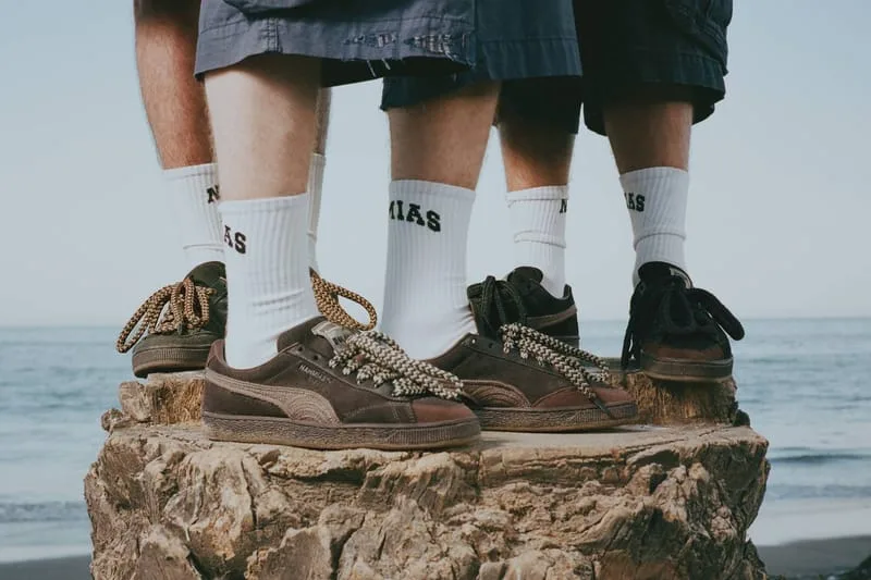 On-foot view of brown pairs with white socks on a tree stump, sea in the background, NAHMIAS Suede Crochet