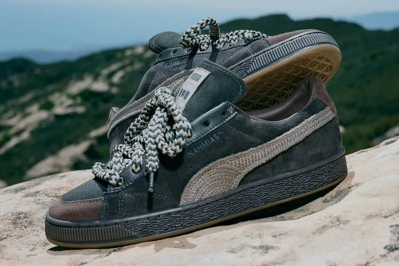 Lateral view of a grey-brown pair with crochet-textured stripe and braided laces on a rock above hills, NAHMIAS Suede Crochet