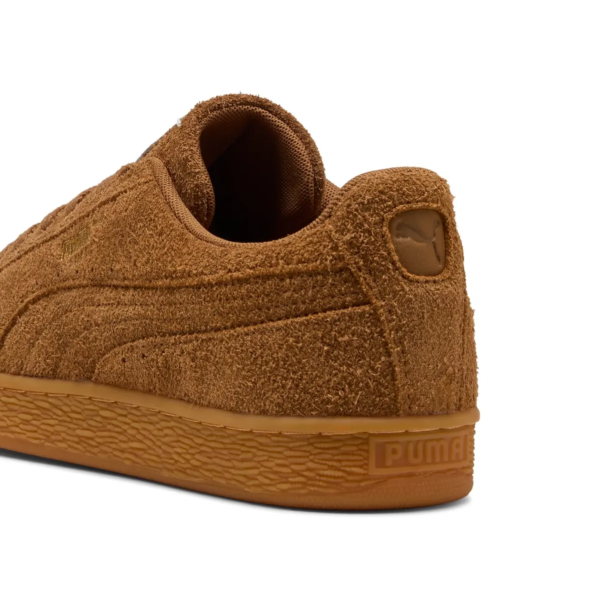 Heel detail of brown shaggy suede with a tonal cat logo and gum sole, Forever