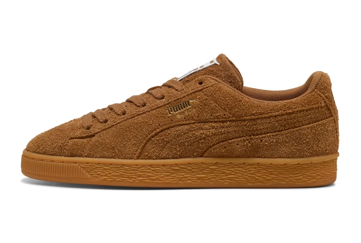 Lateral view of brown shaggy suede with gold Puma branding and a gum sole, Forever