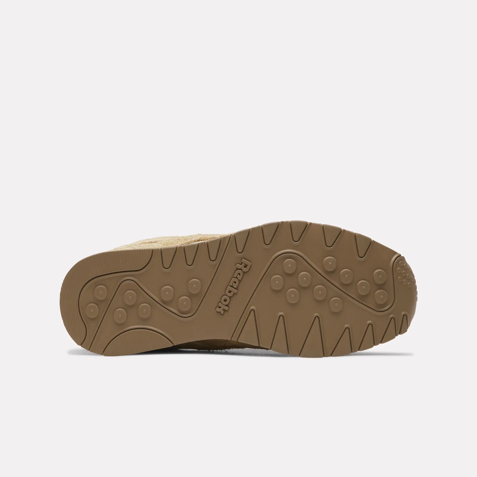 Outsole view in brown rubber with a raised Reebok logo and circular studs, Four Nations