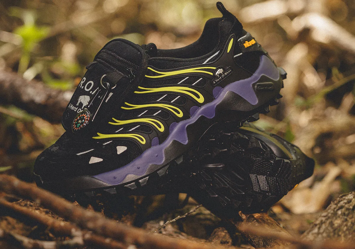 Lateral view on forest floor, compass on pocket, purple midsole, neon ribs, leafy background, Reebok DMX Trailzilla