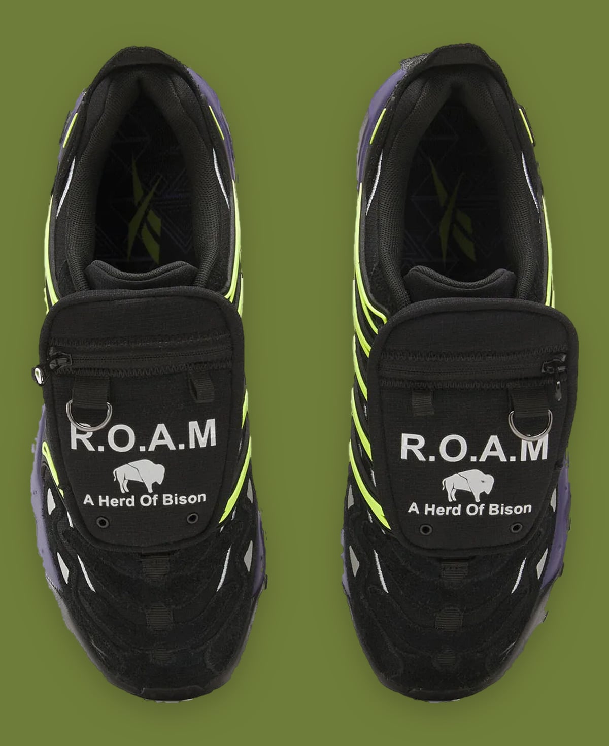 Top-down pair on green backdrop, R.O.A.M bison print on black pockets, neon yellow ribs, Reebok DMX Trailzilla