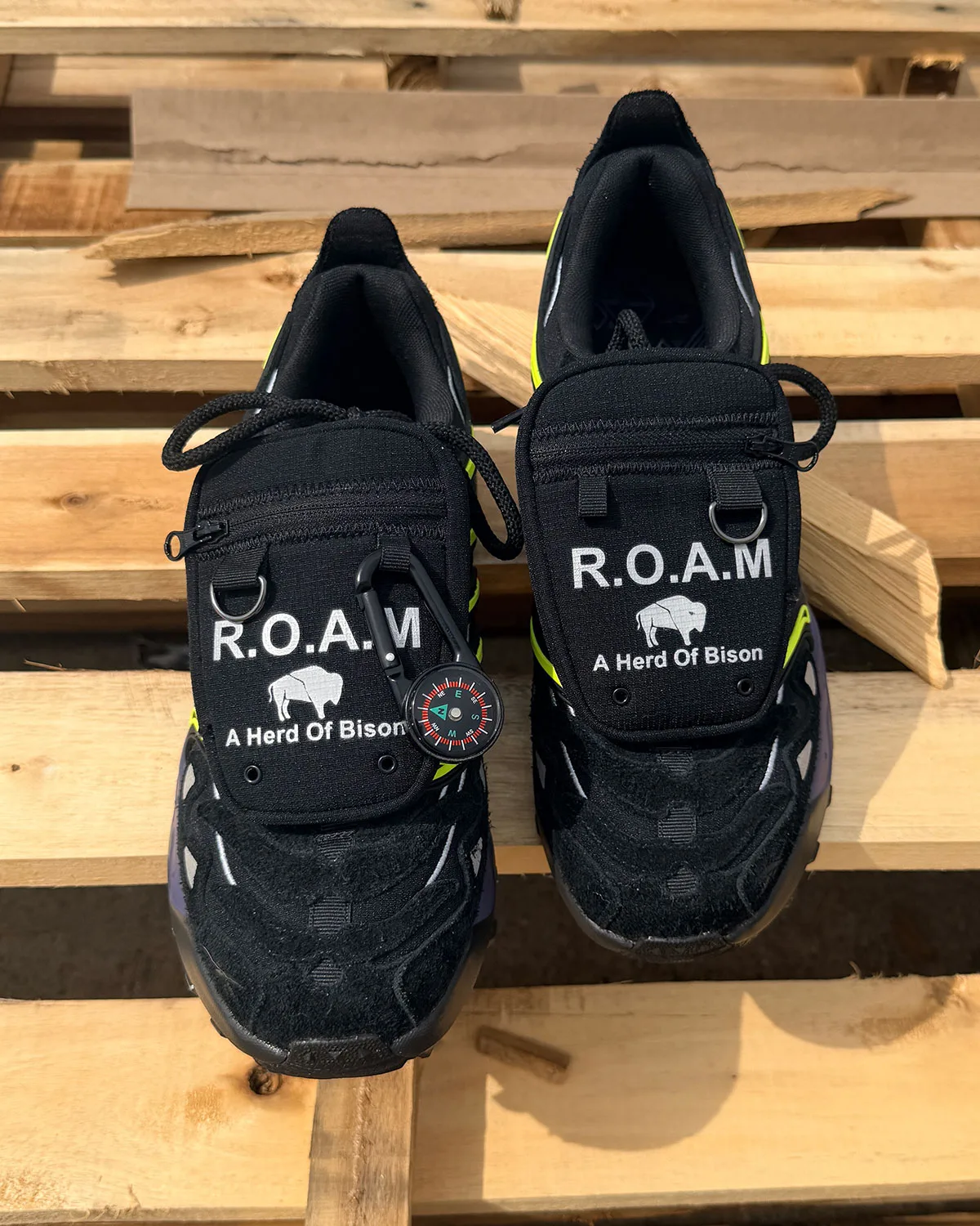 Top-down pair on wooden pallets, R.O.A.M pockets with compass on left shoe, Reebok DMX Trailzilla