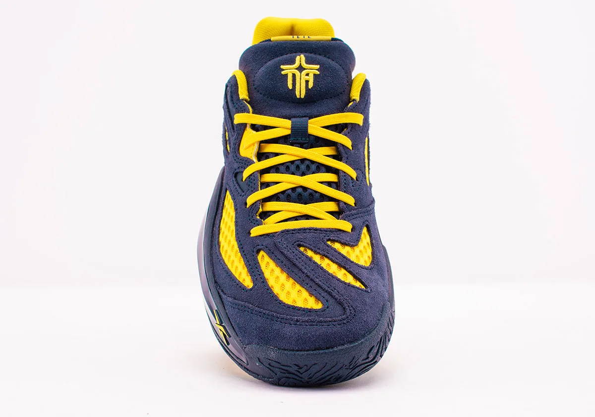 Toe-on front view, yellow laces, embroidered yellow tongue logo, white backdrop, Brew Crew
