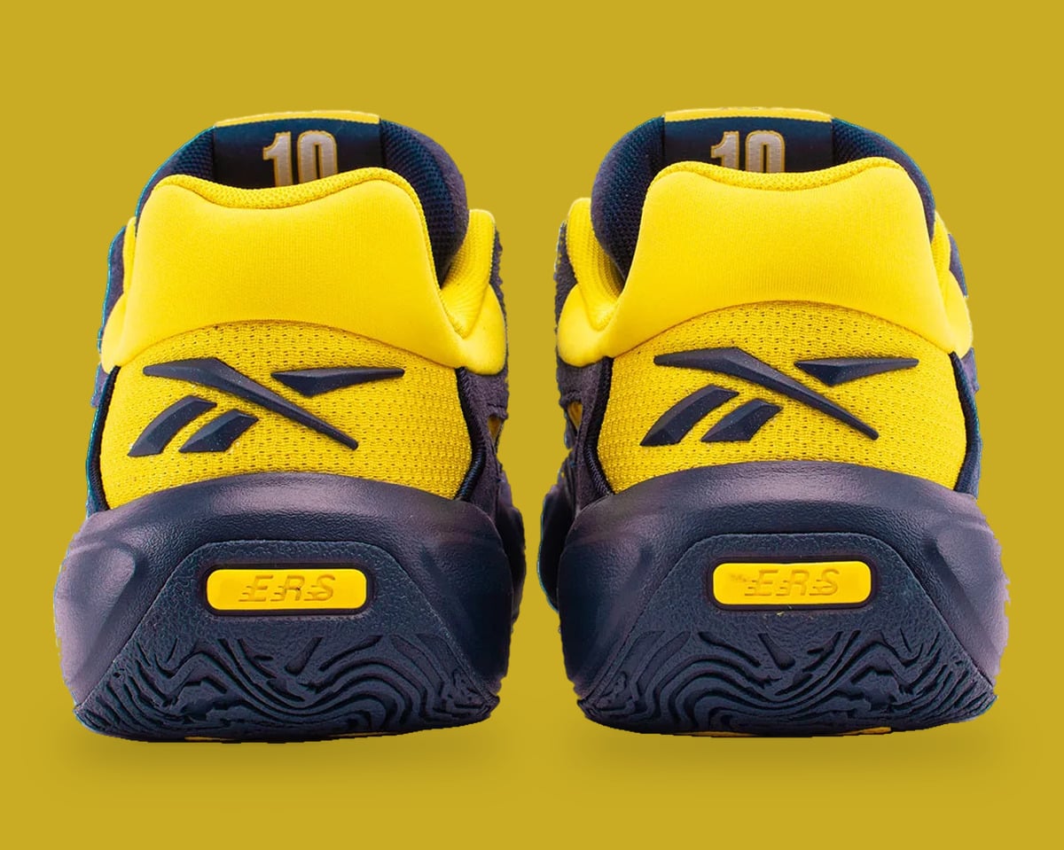 Heel view of pair, yellow heel tabs with navy Reebok vector, number 10 inside collar, Brew Crew