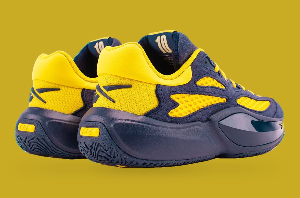 Rear three-quarter pair view, yellow heel counters, navy midsole, number 10 on lining, Brew Crew