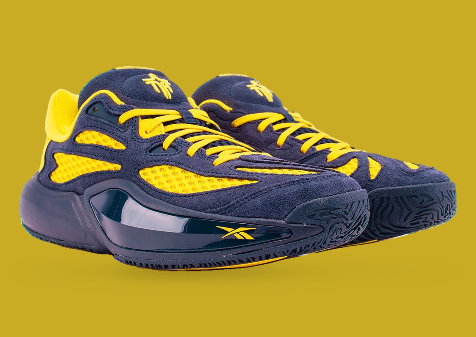 Pair at three-quarter angle on mustard backdrop, navy suede, yellow mesh, yellow laces, Brew Crew