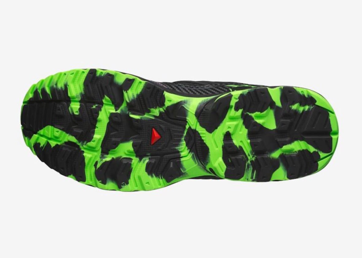 Bottom view of the ACS NEXXT with black and neon-green tread and a red Salomon emblem