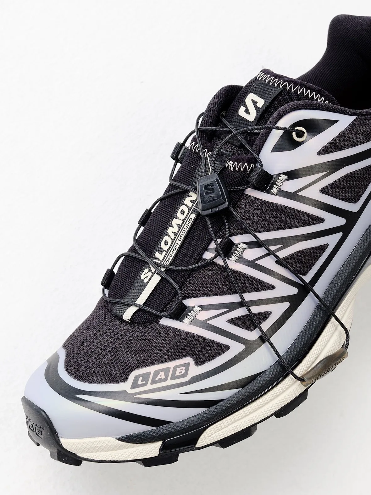 Close detail of toe and laces, LAB badge, SALOMON lace tag, lilac and black overlays, 5 AM