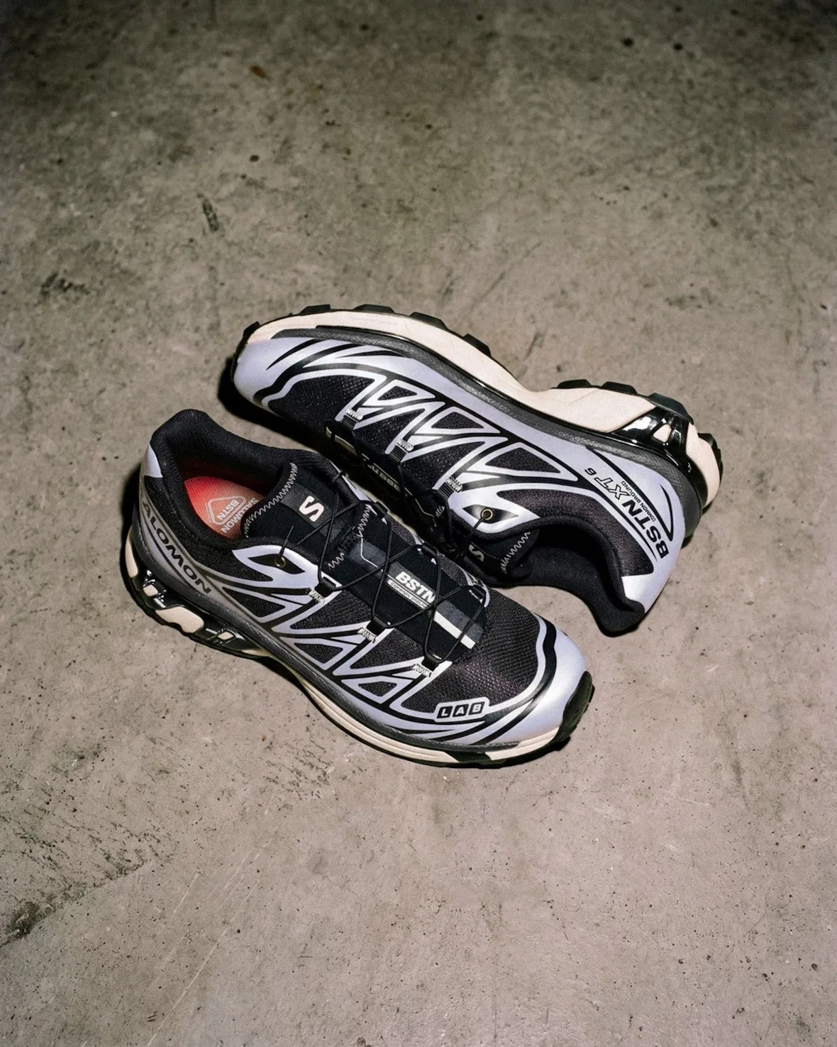 Pair on a concrete floor, BSTN XT-6 text on side, lilac and black, red insole, 5 AM