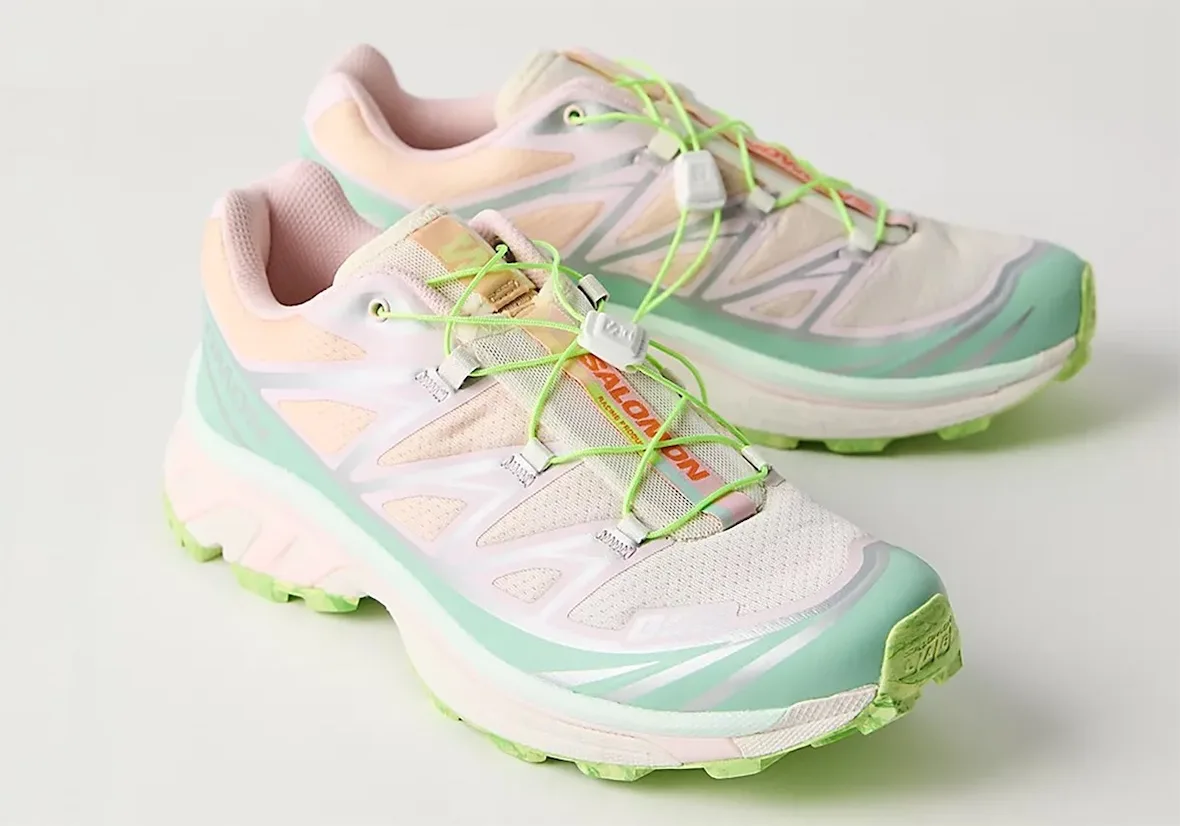 Pair in mint, pink and peach with neon green laces and orange Salomon lettering on the tongue, x FP Movement