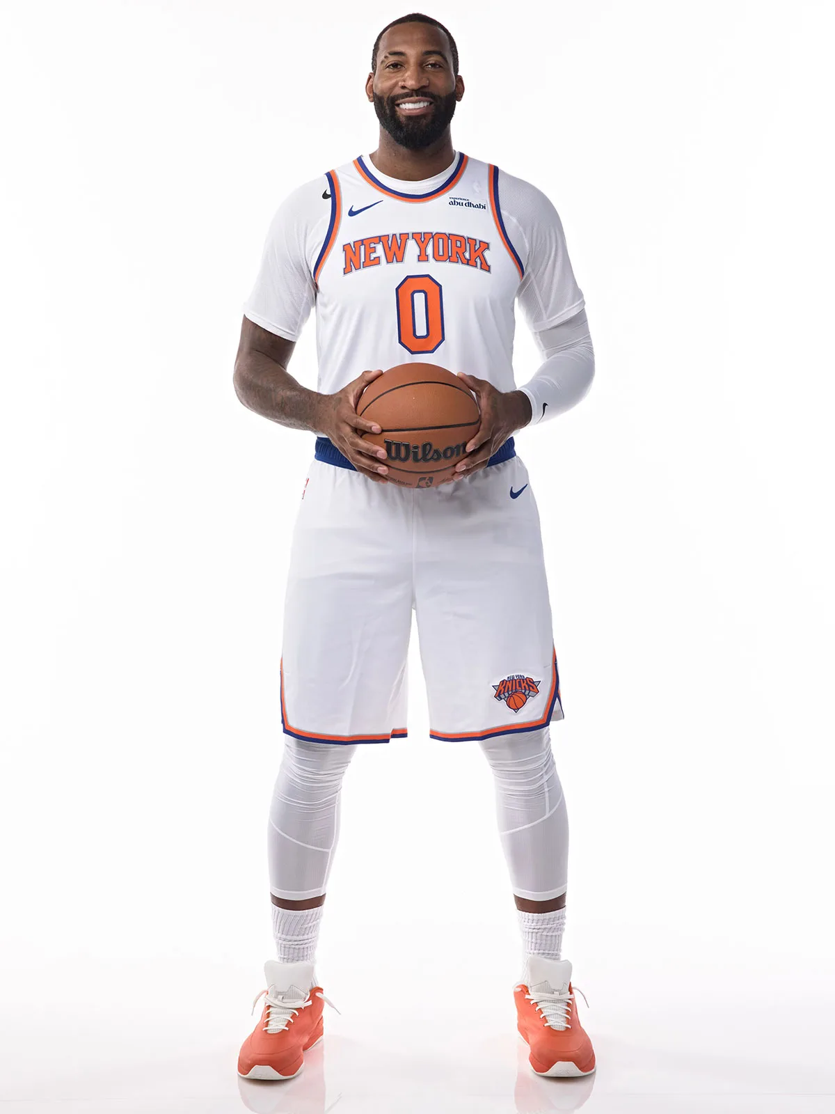 On-foot full-length studio shot, orange sneakers with white laces and heel tabs, white New York jersey, basketball, Sport