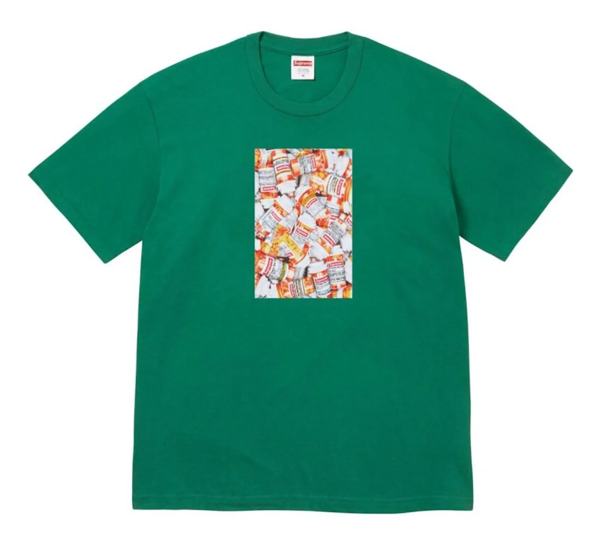 Front of green tee with a rectangular print of piled orange prescription pill bottles, 2026 Tees Collection