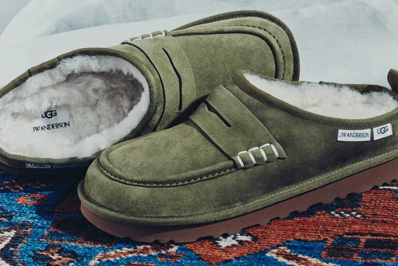 Pair of olive suede loafer clogs on a blue and red patterned rug, with JW Anderson and UGG labels visible, x JW Anderson