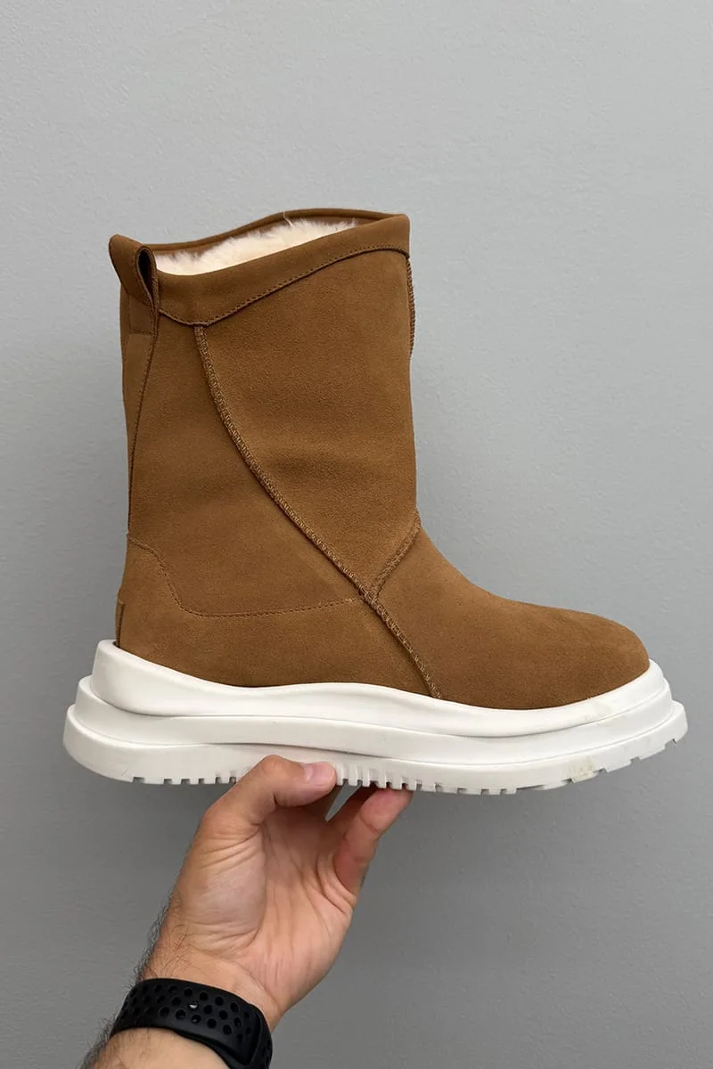 In-hand lateral view of tan suede boot with white shearling collar and chunky white sole, Heritage Utility Grizz