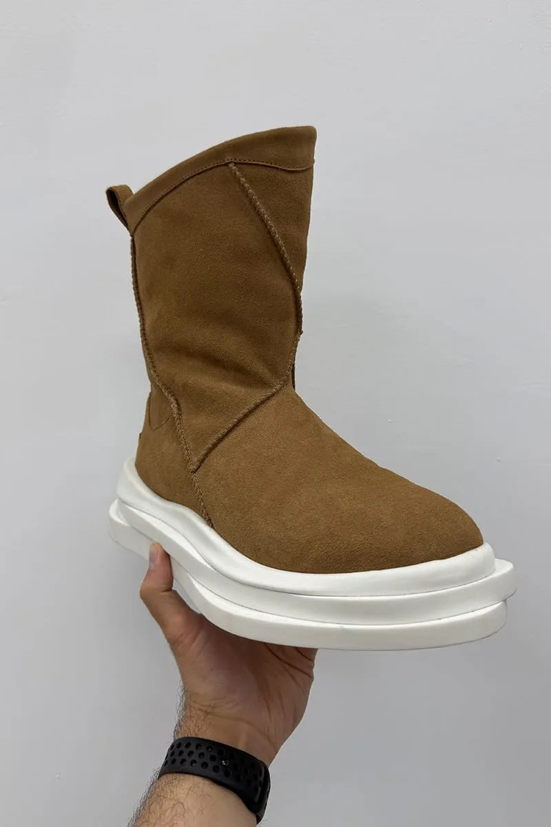 In-hand view of tan suede boot with diagonal seam and stacked white platform sole, Heritage Utility Grizz