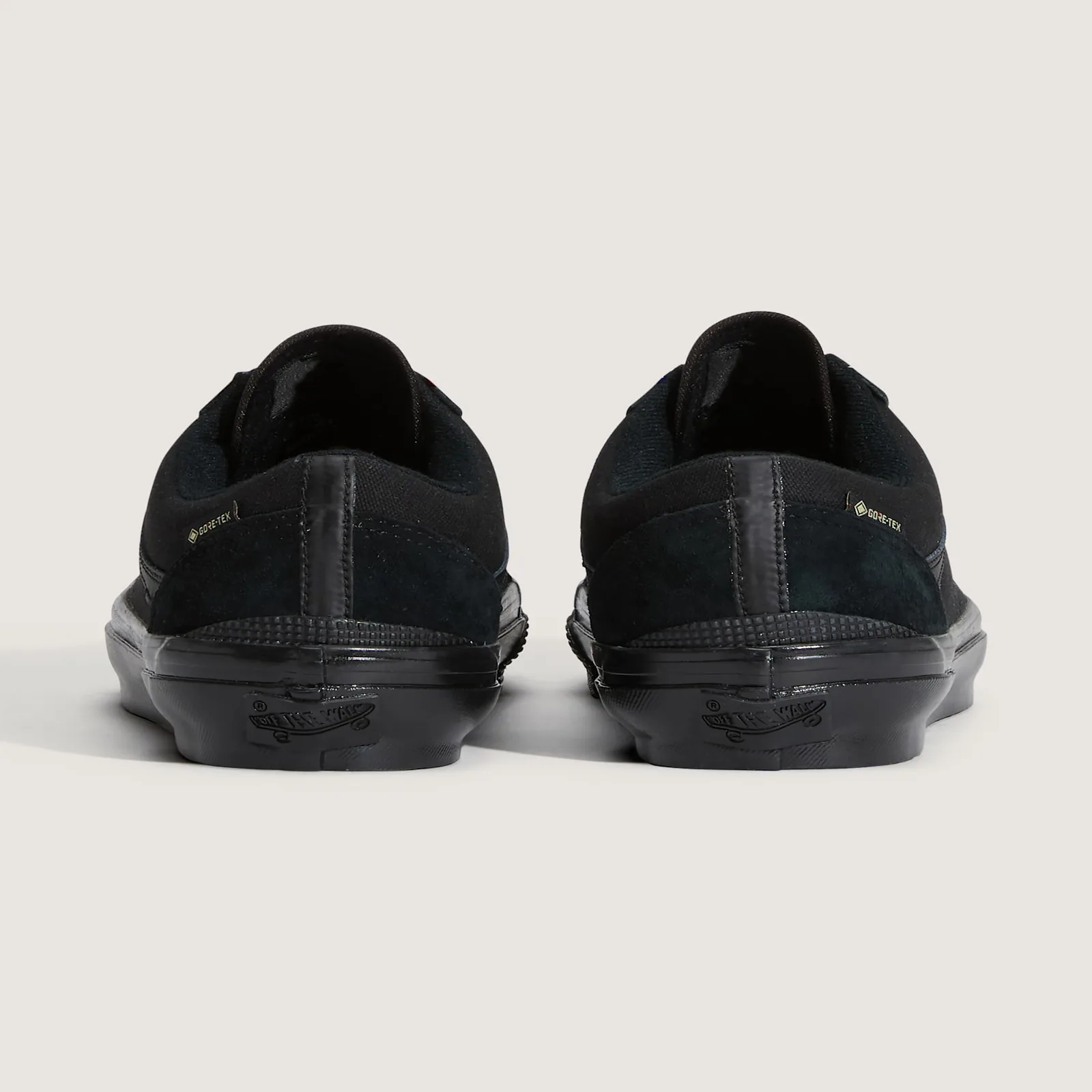 Heel view of a pair, black suede and canvas with Gore-Tex tags and Off the Wall heel labels, 36 GORE Tex