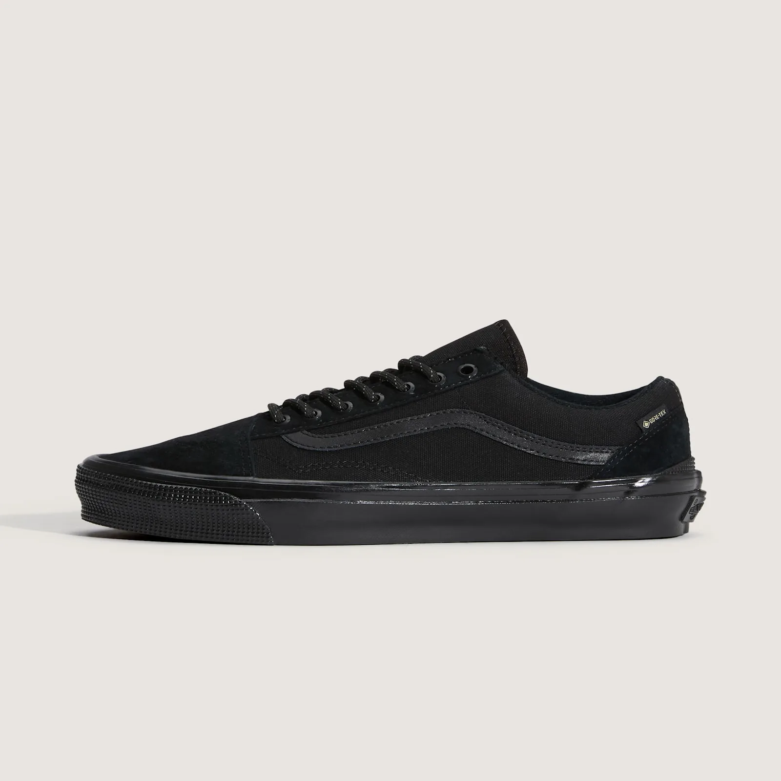 Medial view of an all-black low-top with side stripe, Gore-Tex tag and Vans heel label, 36 GORE Tex