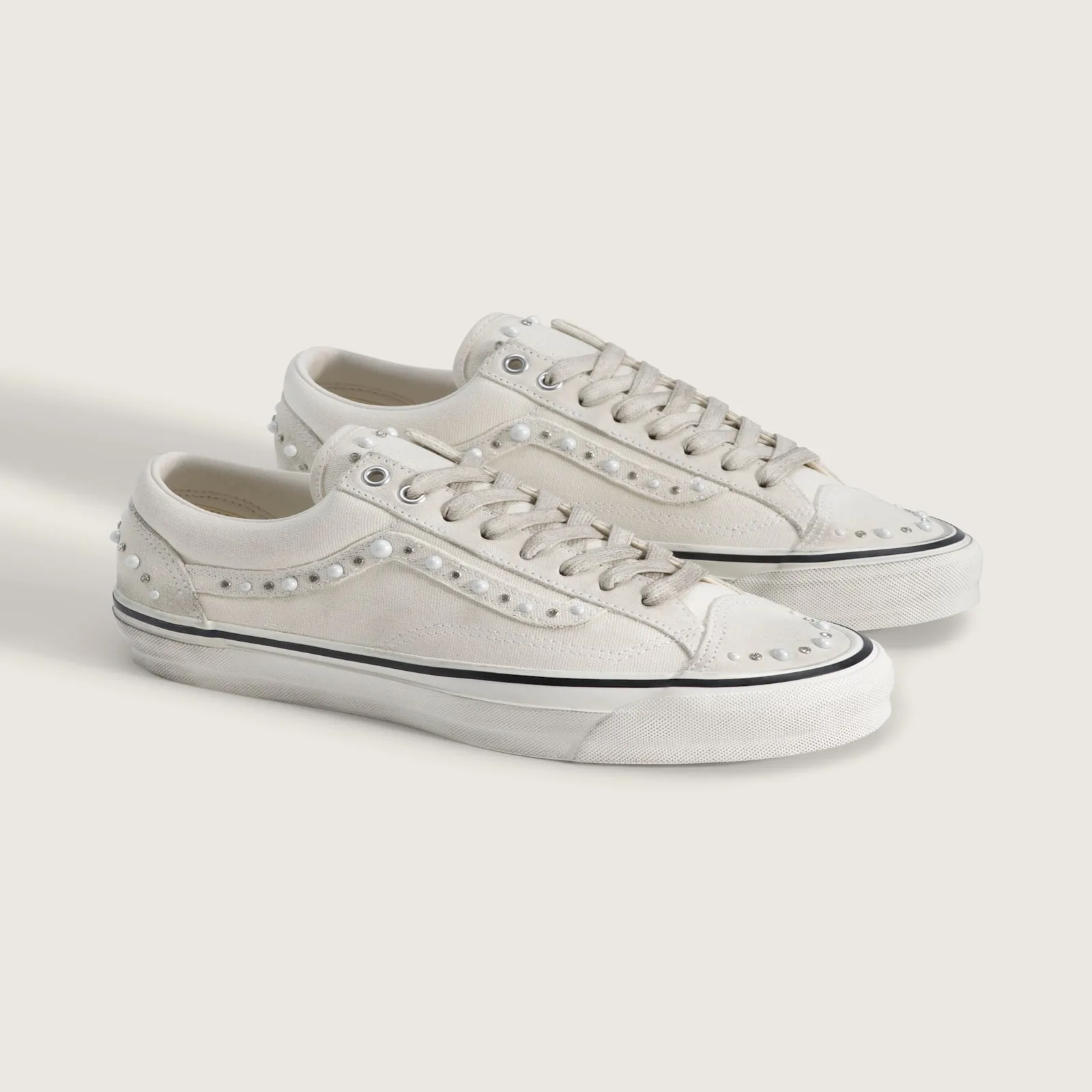 pair at angle, pearl and crystal studs on toe caps and sidewalls, cream backdrop, Marshmallow