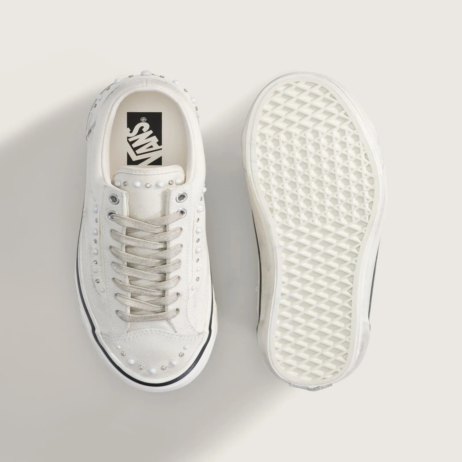 pair top-down, one shoe showing Vans branded insole, other showing tread outsole, Marshmallow