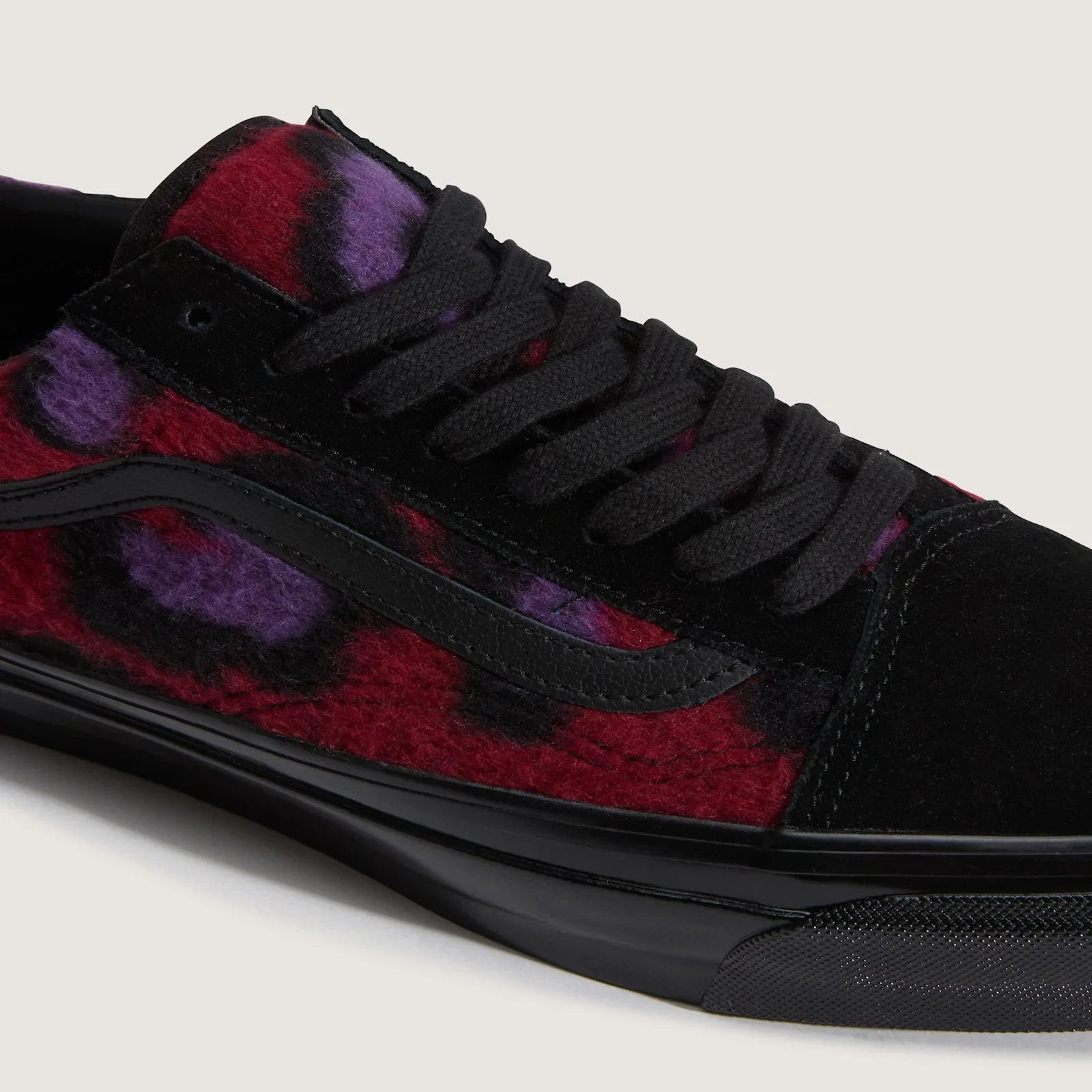 Detail of red fleece with purple and black leopard spots, black leather stripe, black suede toe cap and laces, Leopard Print