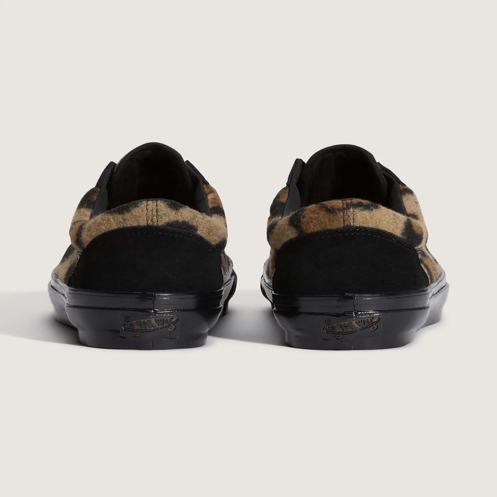 Heel view of the pair, tan leopard fleece collars, black suede heel tabs, black soles with Off the Wall logo, Leopard Print