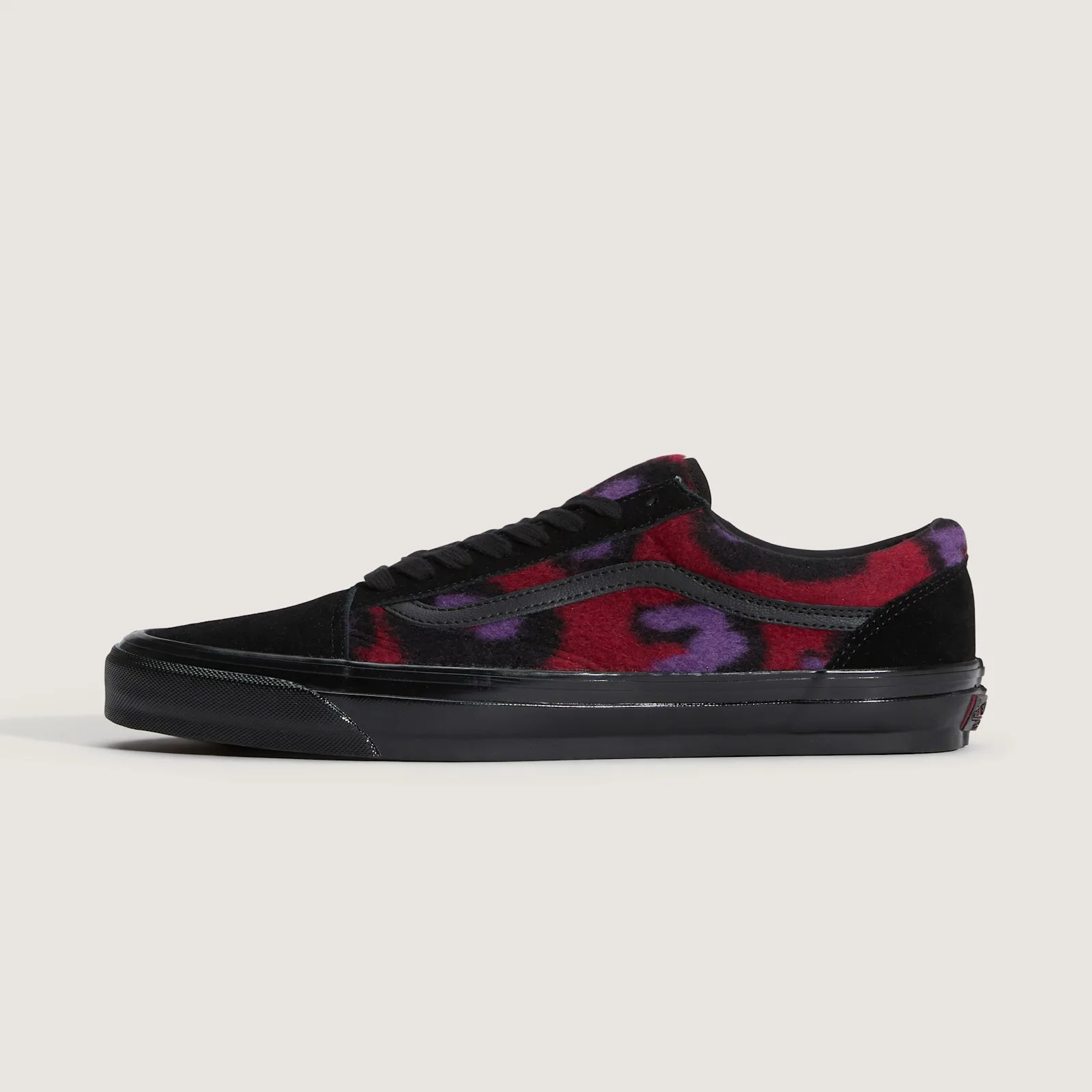 Lateral view, red fleece with purple and black leopard spots, black suede toe and heel, black stripe and sole, Leopard Print