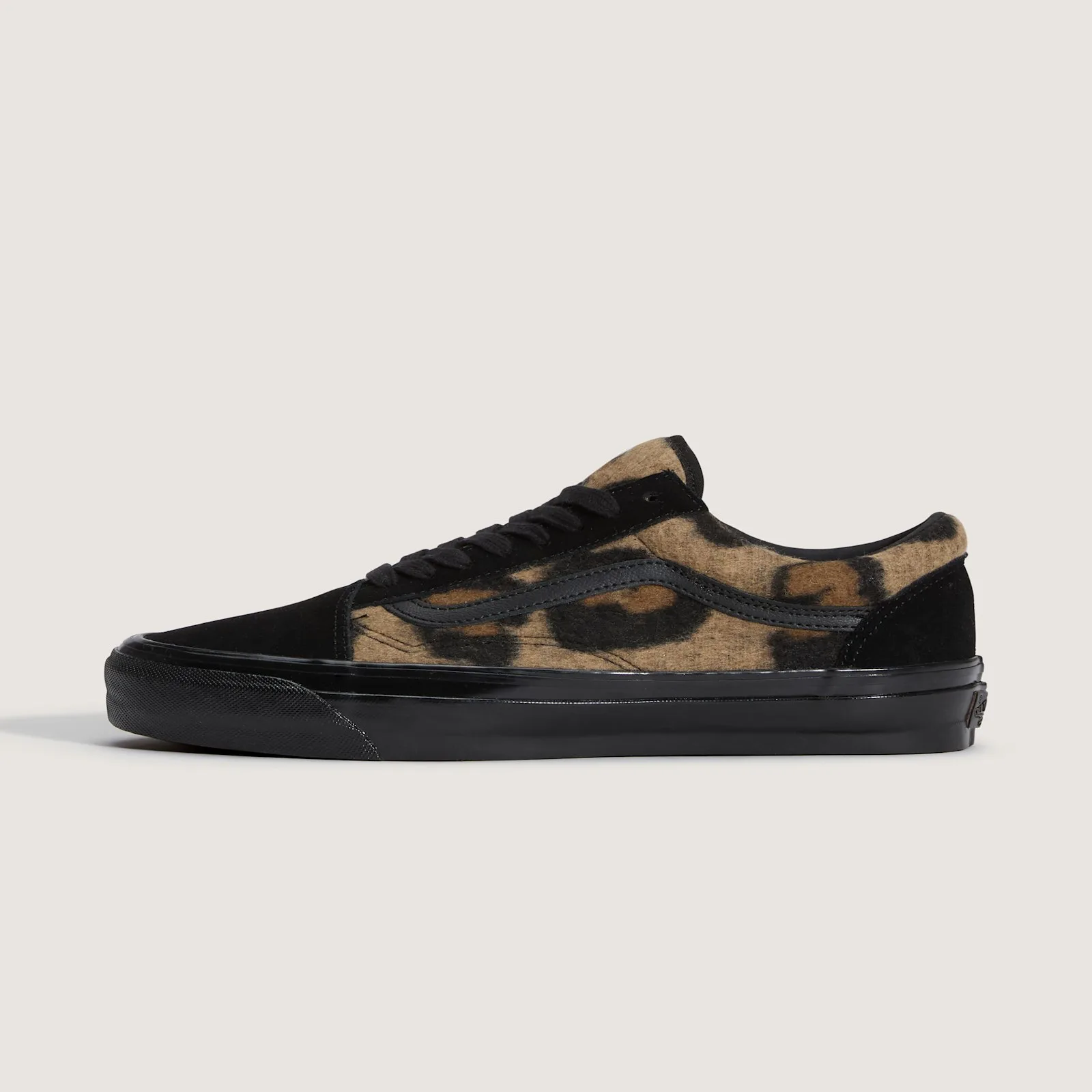 Lateral view, tan leopard-print fleece panel, black suede toe and heel, black leather stripe, all-black midsole, Leopard