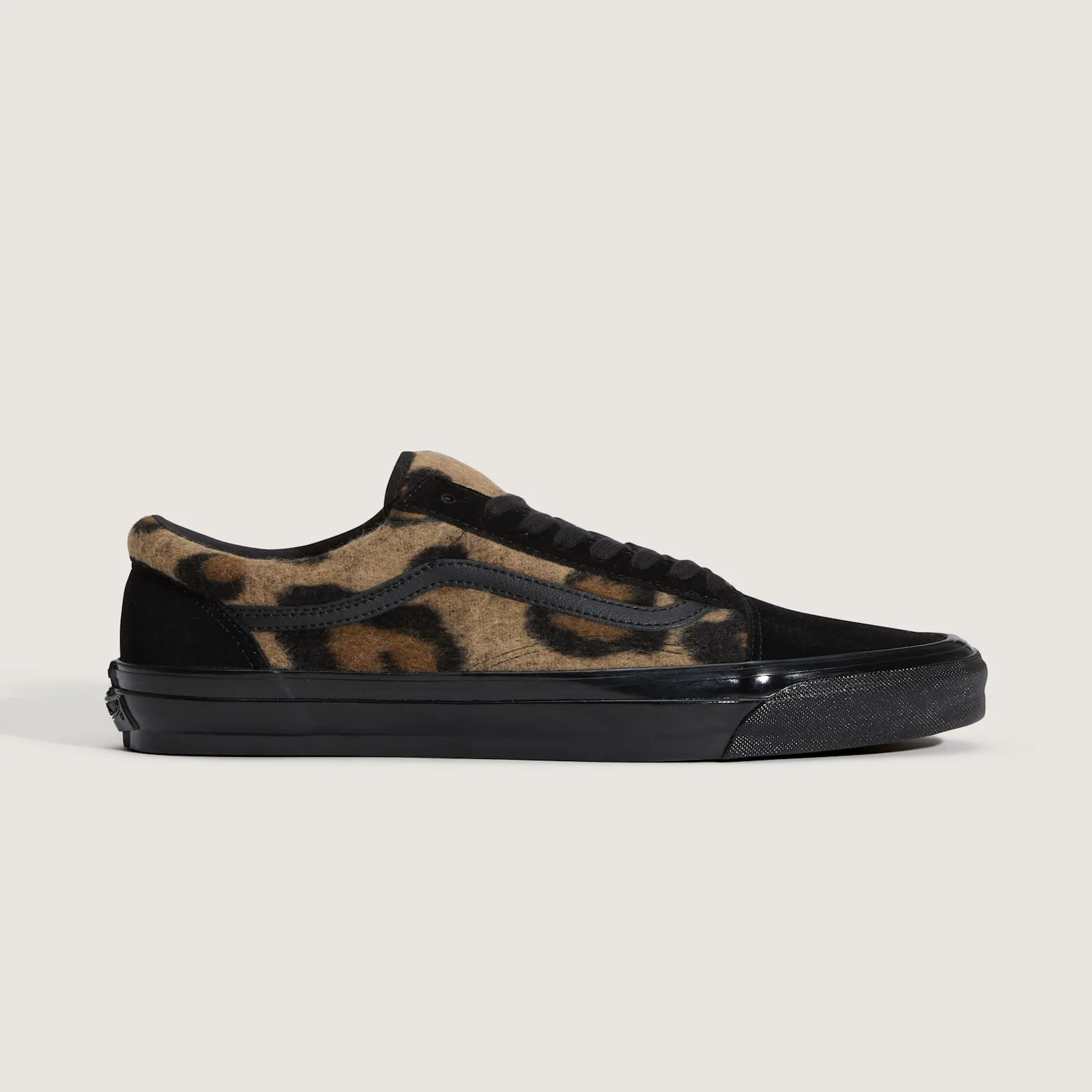 Medial view, tan leopard-print fleece with black stripe, black suede heel and toe, glossy black midsole, Leopard Print