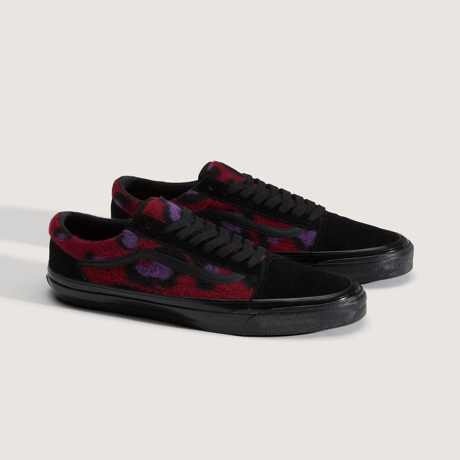 Pair at an angle, red fleece with purple leopard spots, black suede toes, black laces and black midsoles, Leopard Print