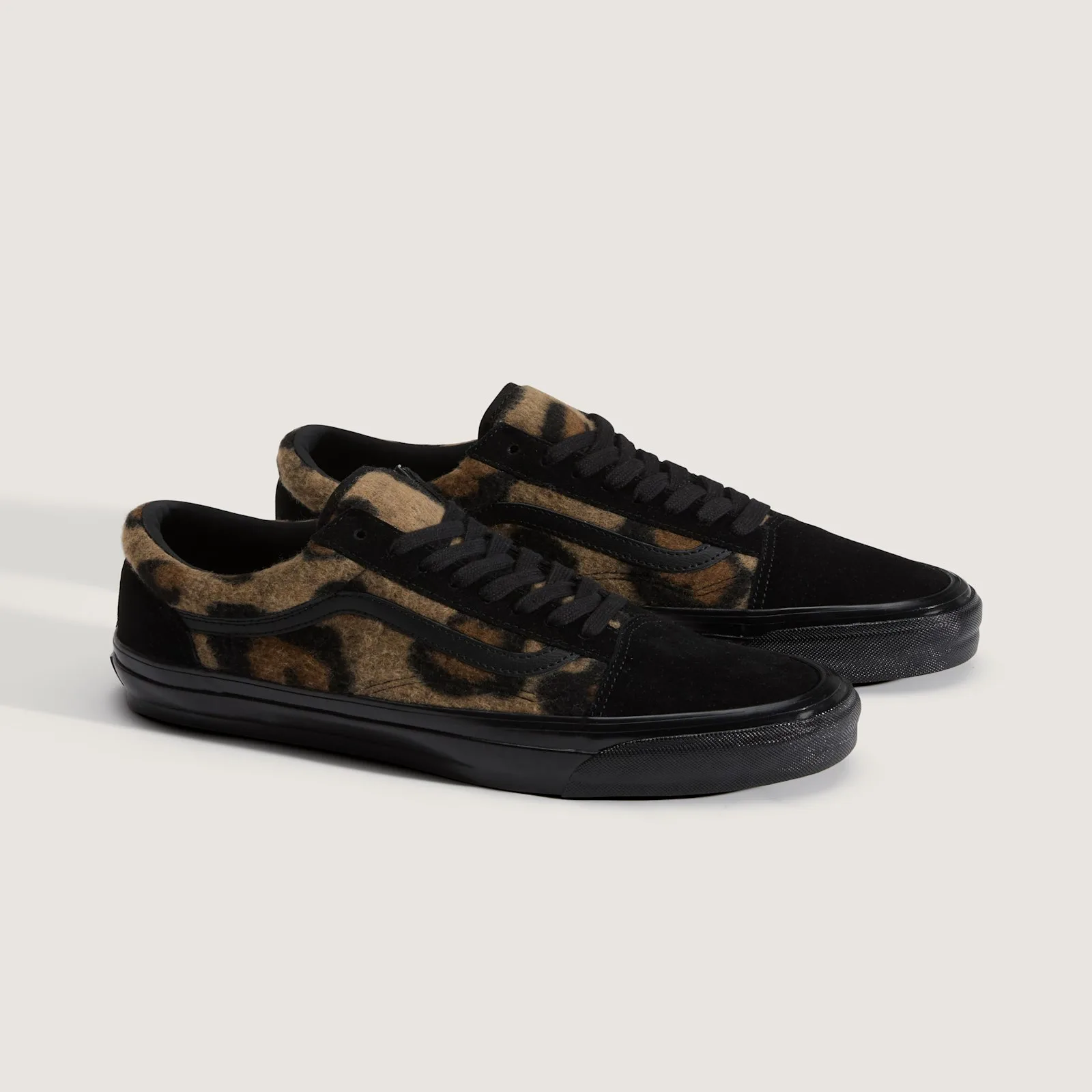 Pair at an angle, tan leopard-print fleece quarters, black suede toes, black laces and black midsoles, Leopard Print