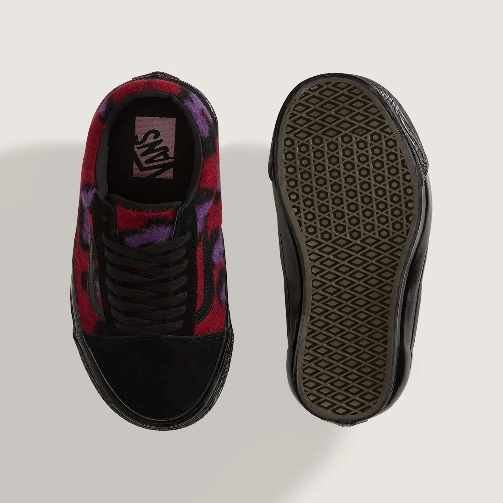 Top-down view of one shoe beside its outsole, red and purple leopard fleece, black laces, Vans insole, waffle tread, Leopard