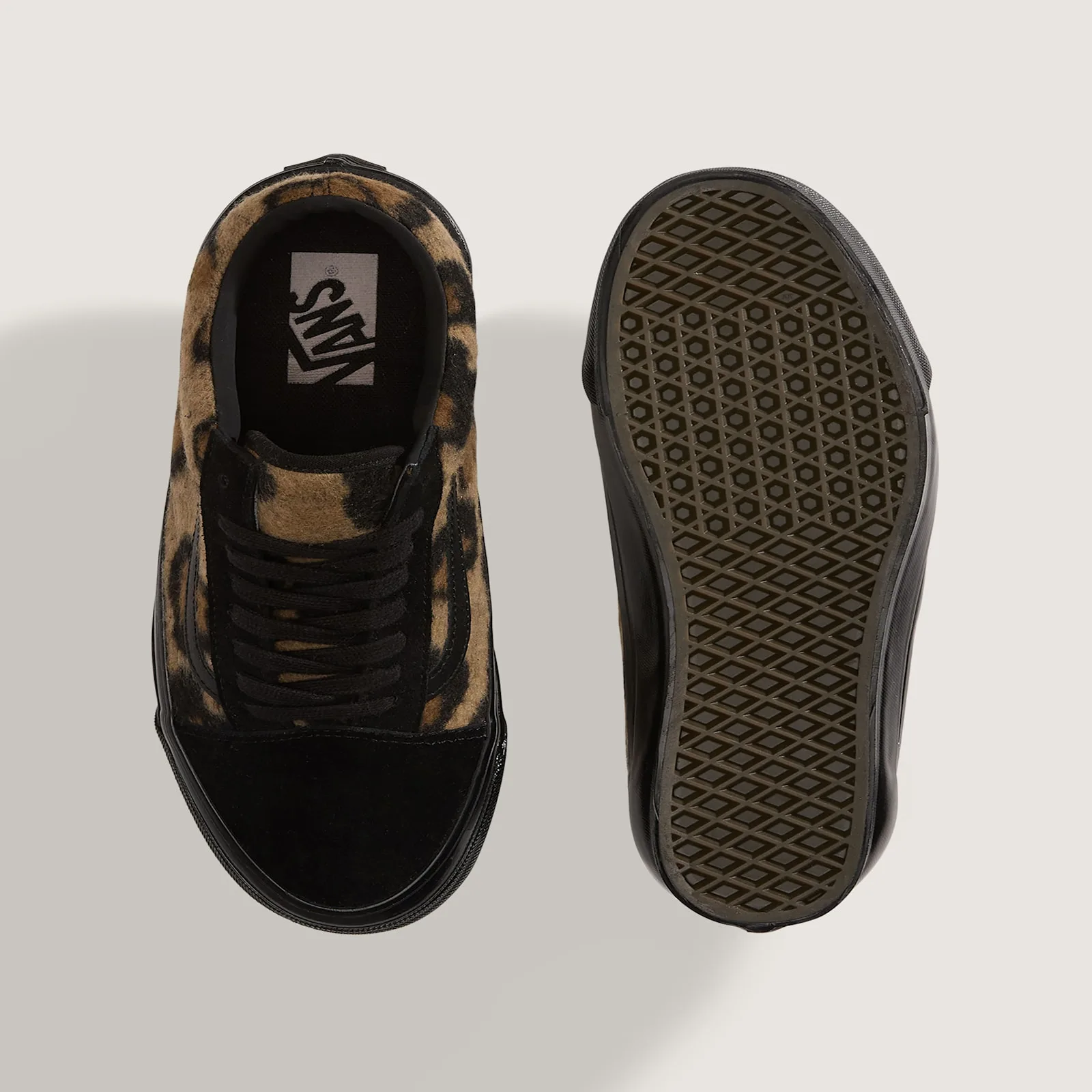 Top-down view of one shoe beside its outsole, tan leopard fleece, black laces, Vans insole logo, waffle tread, Leopard Print