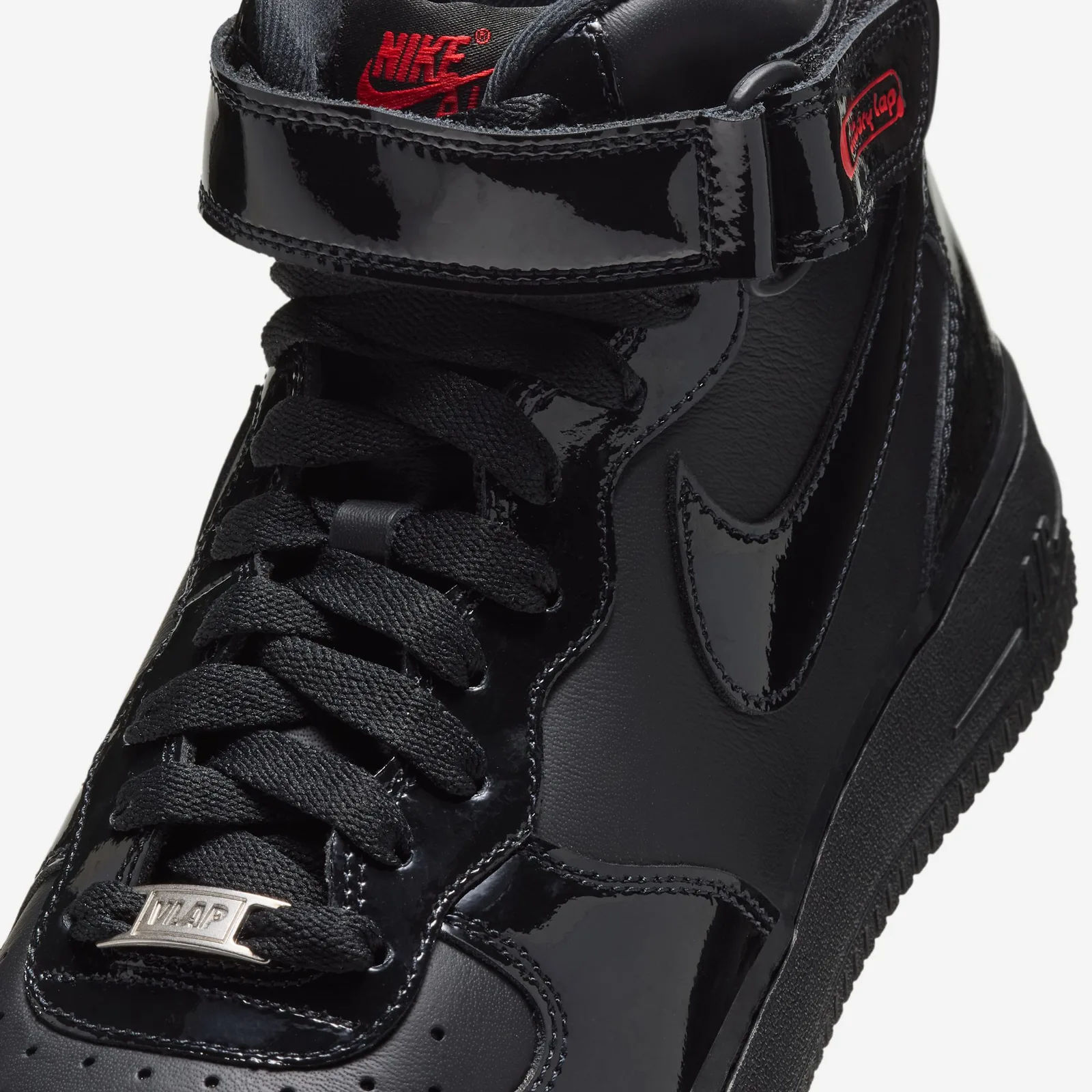 Close-up of laces, silver VLAP lace tip, patent strap and red Nike Air tongue label, Black Patent
