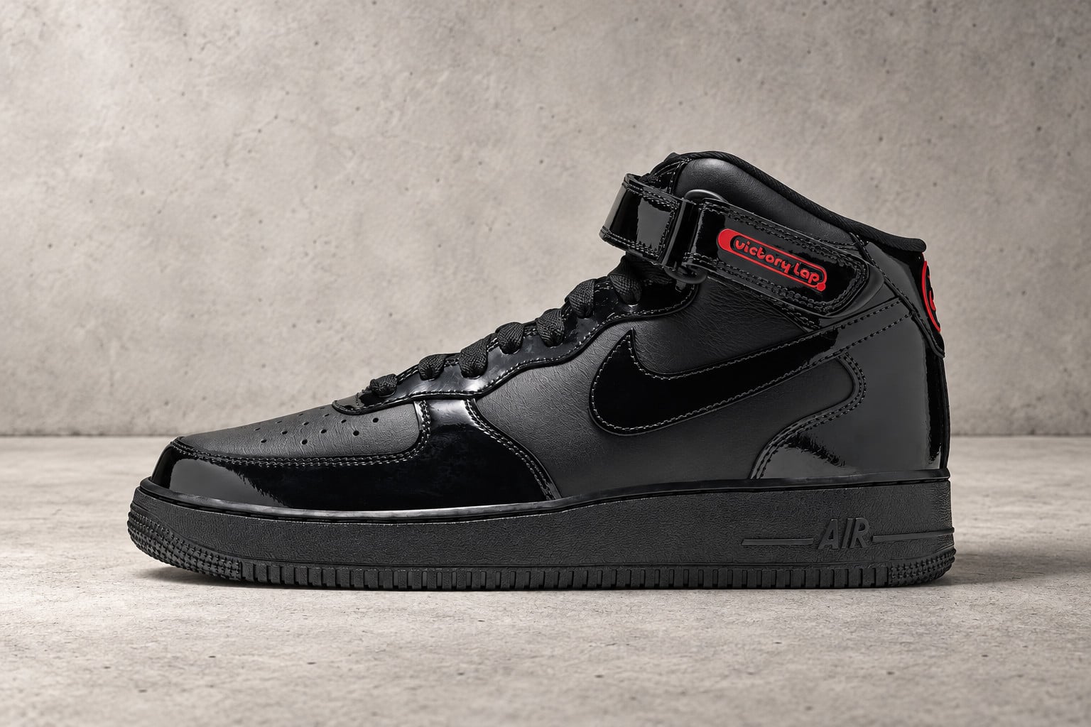 Lateral view on grey concrete, black patent and leather with red, Victory Lap Radio x Nike Air Force 1 Mid “Black Patent”