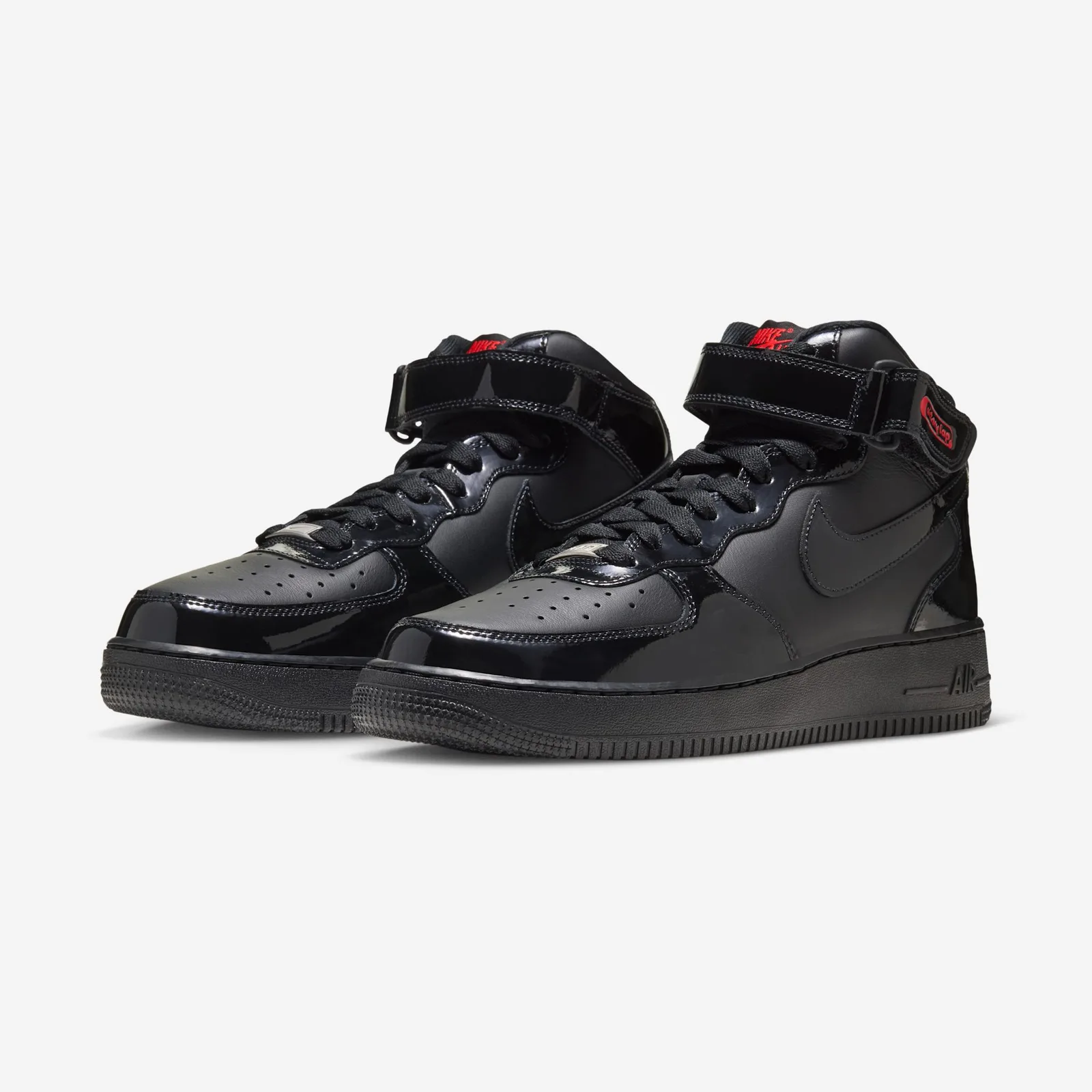 Pair at three-quarter angle, black patent toe caps and straps with red tongue labels, Black Patent